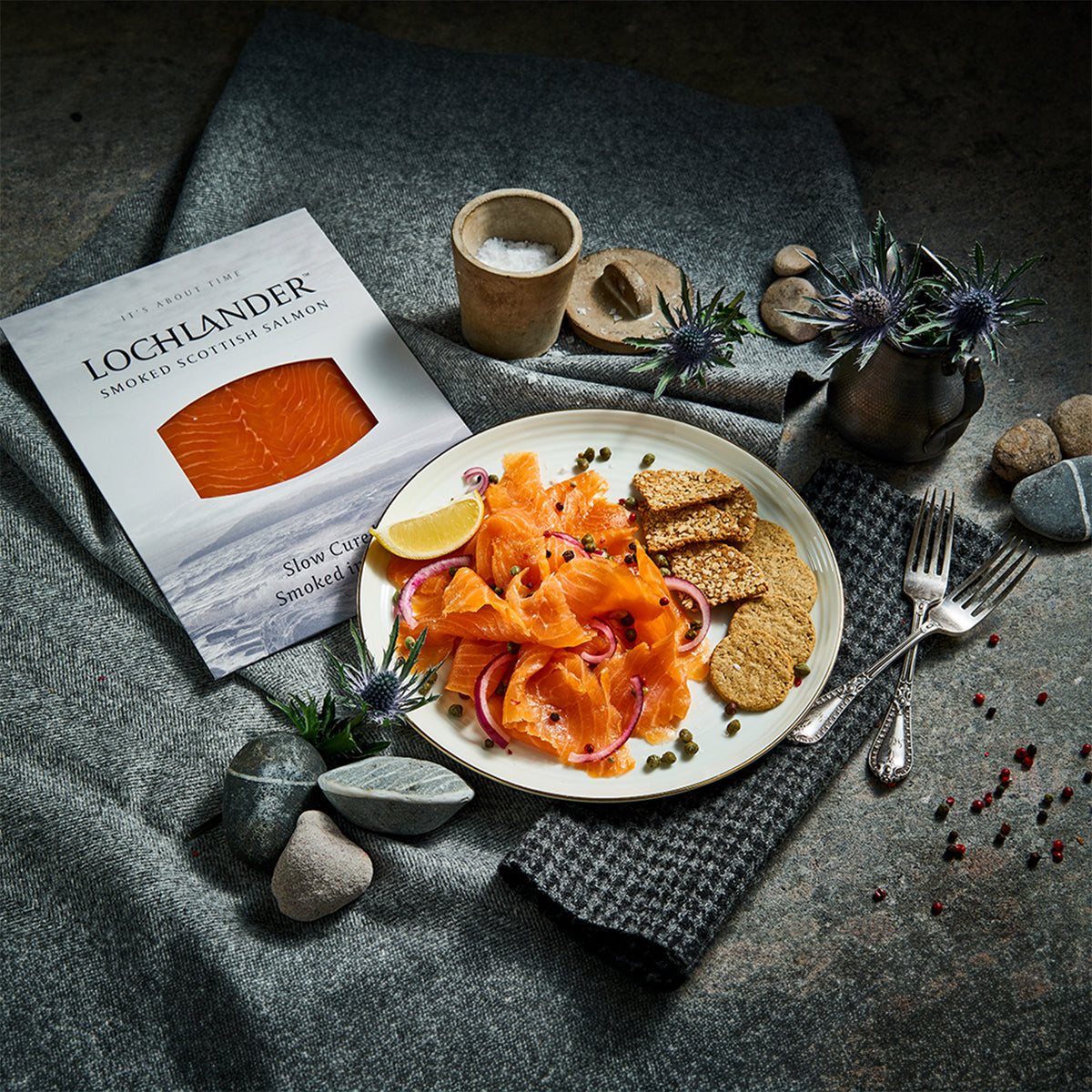 Lochlander and Native Hebridean smoked salmon packages on a textured surface.